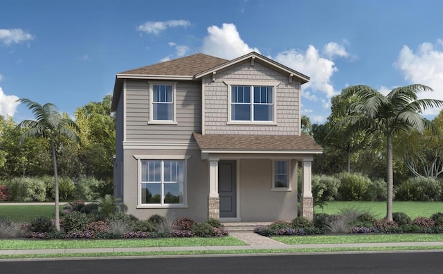 craftsman house featuring roof with shingles, a front yard, and stucco siding