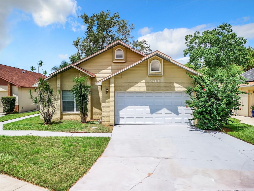 front of property with a garage and a front yard