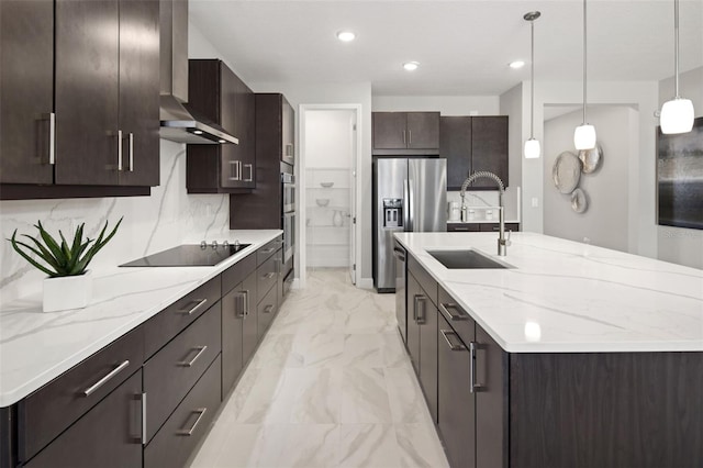 kitchen featuring decorative light fixtures, sink, stainless steel appliances, dark brown cabinets, and wall chimney exhaust hood