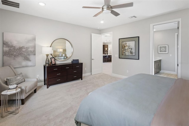 carpeted bedroom featuring ceiling fan and ensuite bath