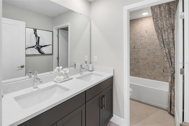 full bathroom with tiled shower / bath, vanity, and toilet