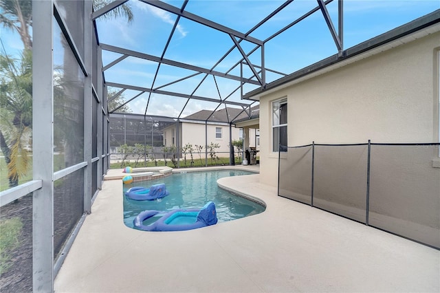 view of pool featuring an in ground hot tub, glass enclosure, and a patio area