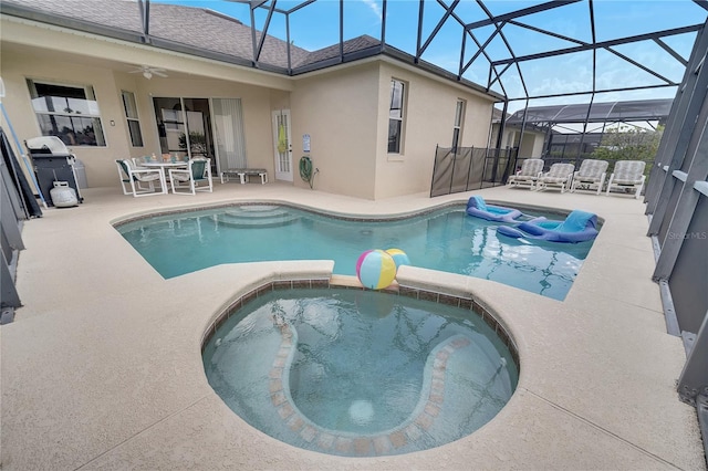 view of pool featuring an in ground hot tub, area for grilling, glass enclosure, and a patio