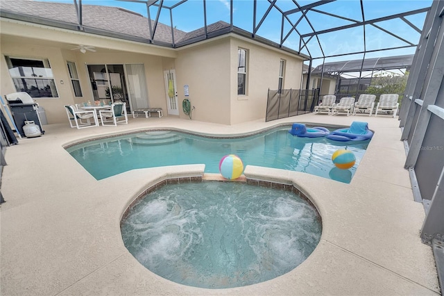 view of swimming pool featuring an in ground hot tub, a lanai, and a patio