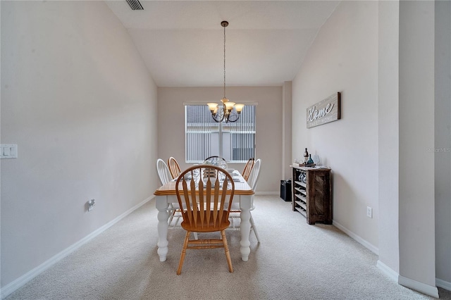 dining space with vaulted ceiling, carpet floors, and an inviting chandelier