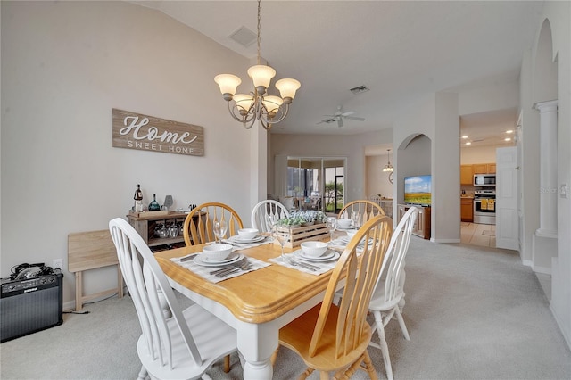 carpeted dining area with vaulted ceiling and a chandelier