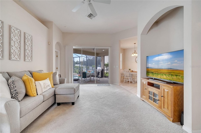 living room featuring light colored carpet and ceiling fan