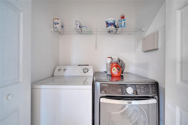 clothes washing area featuring washer and clothes dryer