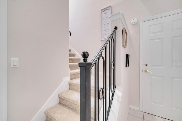 stairway with tile patterned floors