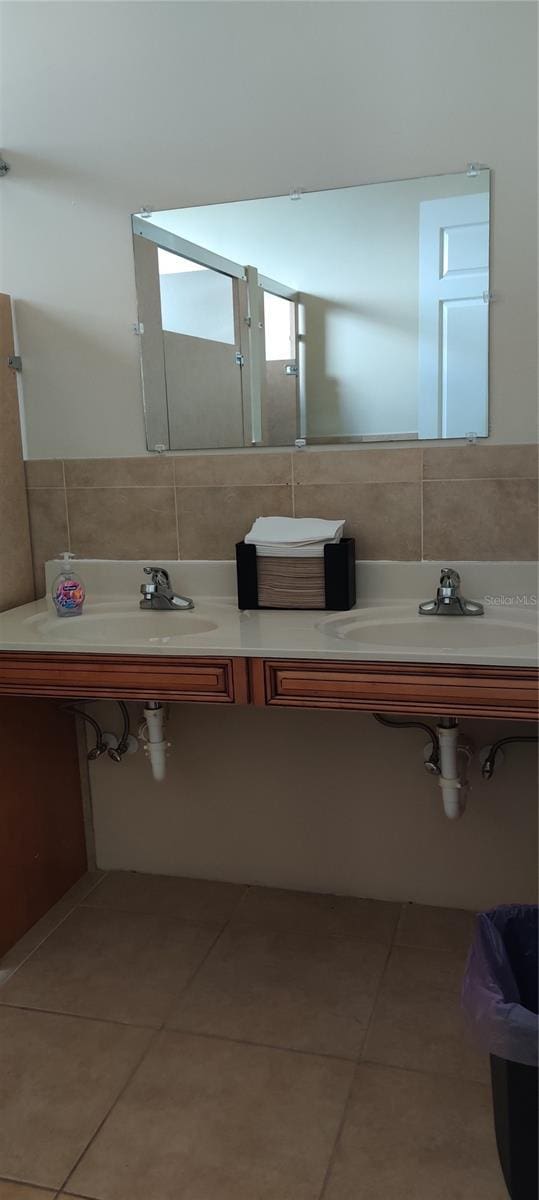 bathroom featuring tile walls, sink, and tile patterned flooring