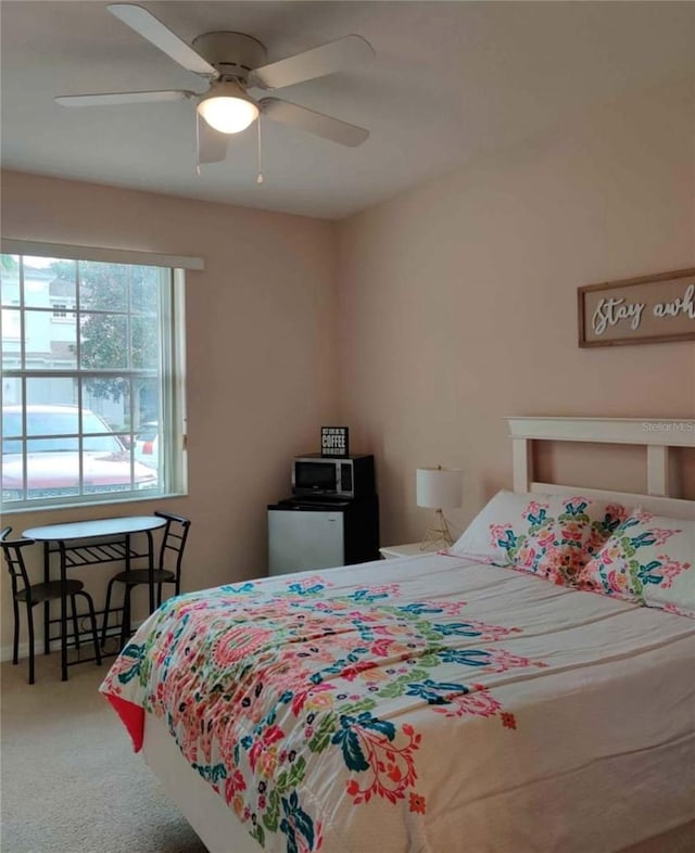 carpeted bedroom with ceiling fan