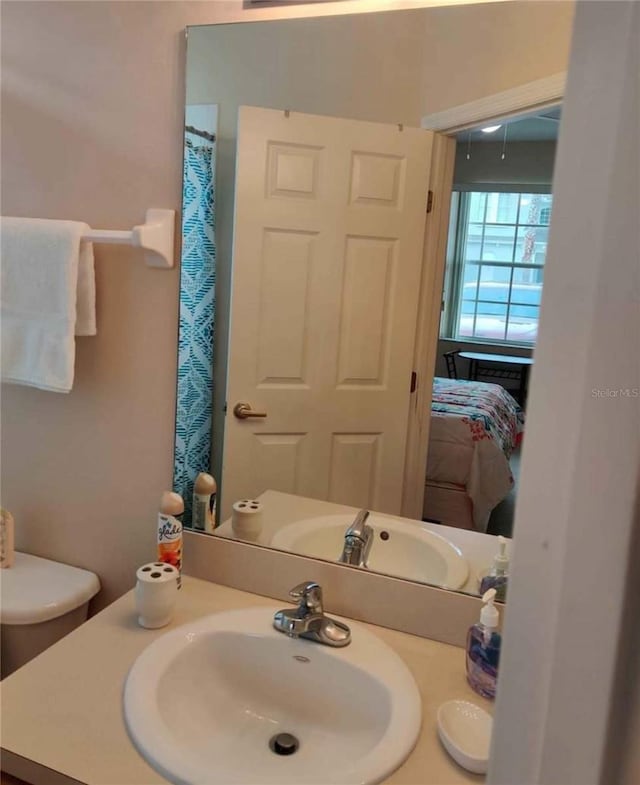 bathroom featuring vanity and toilet