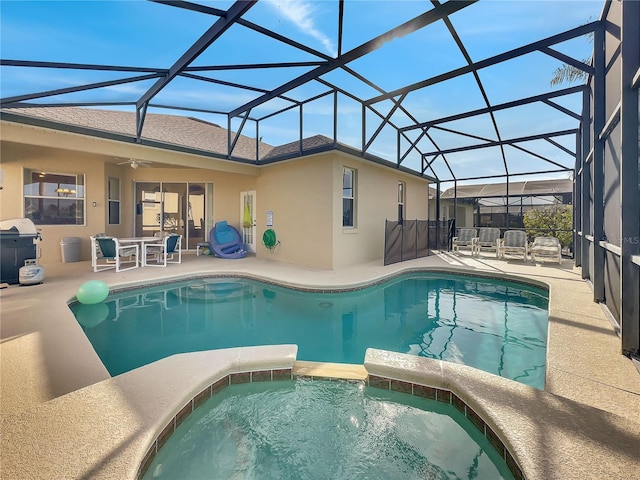 view of swimming pool with an in ground hot tub, a grill, glass enclosure, and a patio