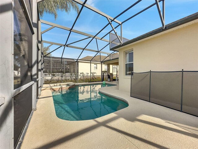 view of swimming pool with a lanai and a patio area