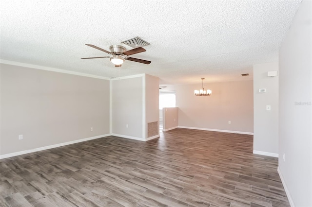 empty room with hardwood / wood-style flooring, ceiling fan with notable chandelier, and a textured ceiling