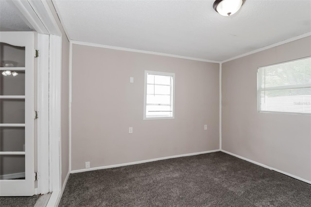 spare room with ornamental molding, a healthy amount of sunlight, a textured ceiling, and dark carpet