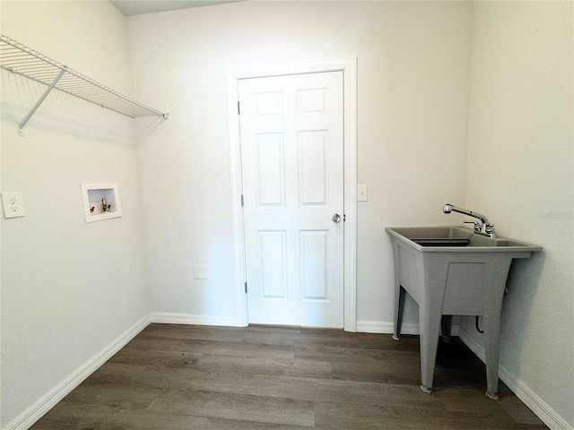 laundry room with dark hardwood / wood-style floors and washer hookup