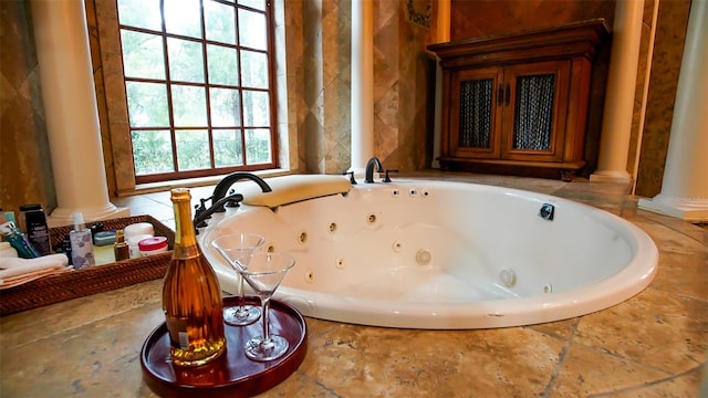 room details featuring a bathtub and ornate columns