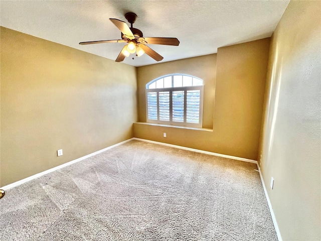 unfurnished room featuring carpet floors, a ceiling fan, baseboards, and a textured ceiling