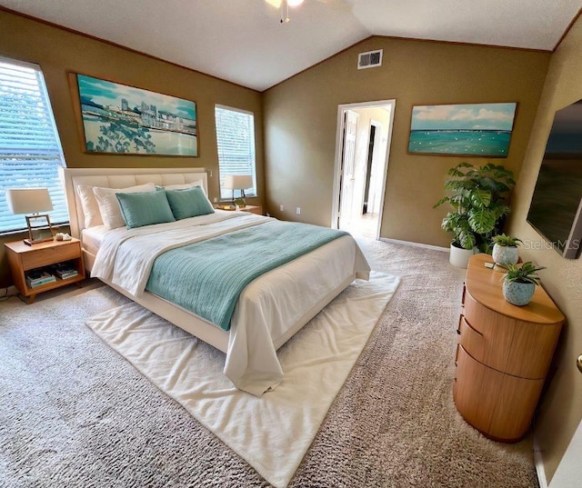 carpeted bedroom featuring lofted ceiling and visible vents