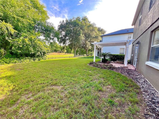 view of yard with fence and a pergola