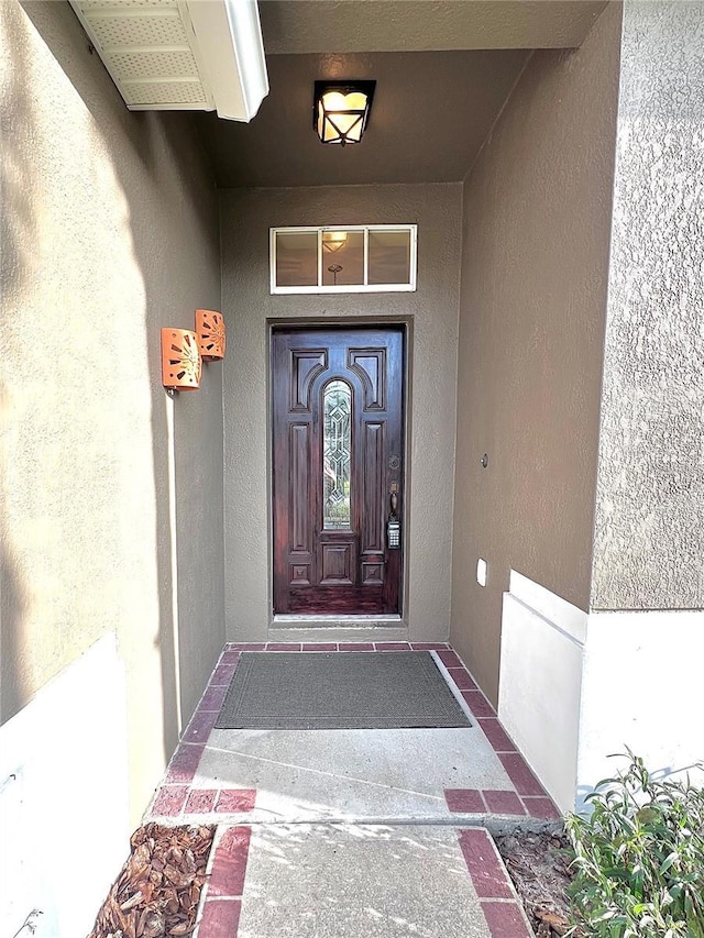 property entrance with stucco siding