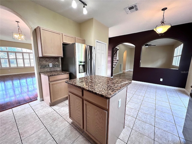 kitchen featuring visible vents, stainless steel fridge, decorative light fixtures, and light tile patterned flooring