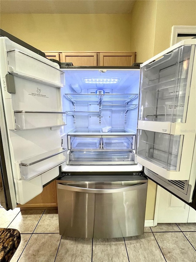 details with brown cabinetry and refrigerator