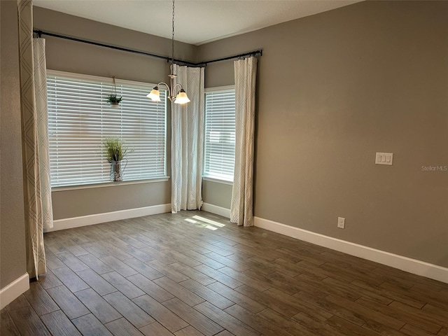 interior space featuring dark wood-type flooring and an inviting chandelier