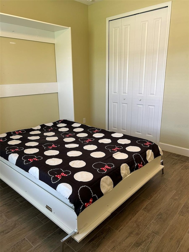 unfurnished bedroom featuring a closet and wood-type flooring