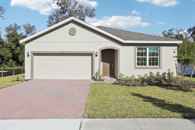 ranch-style home featuring a garage and a front lawn