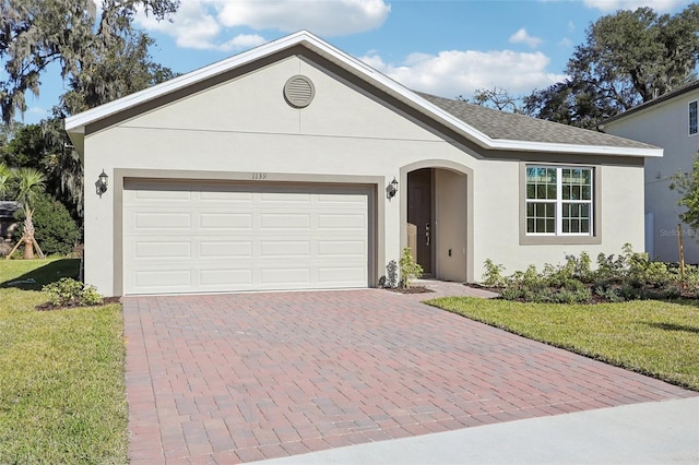 ranch-style house with a front lawn and a garage