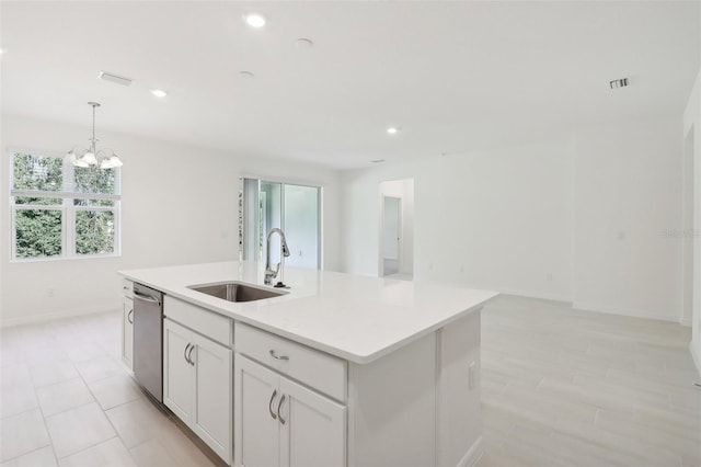 kitchen with dishwasher, sink, hanging light fixtures, an island with sink, and white cabinets