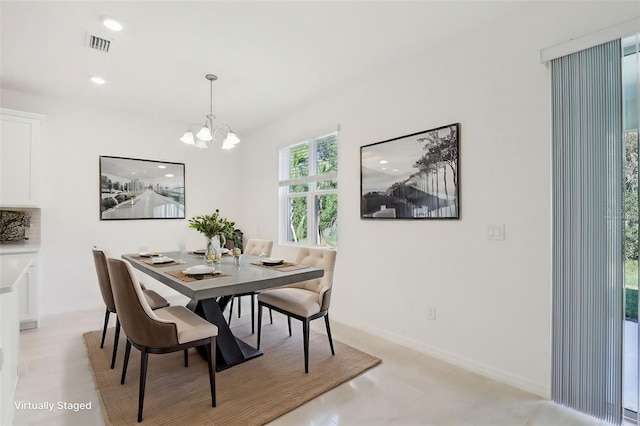 dining space with a notable chandelier