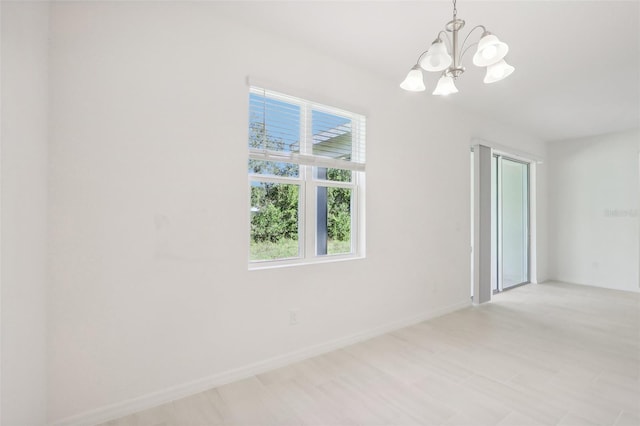 empty room featuring a chandelier