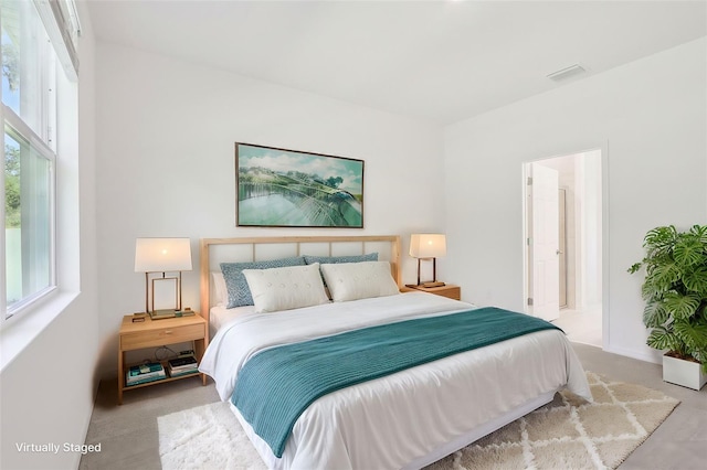 carpeted bedroom with connected bathroom