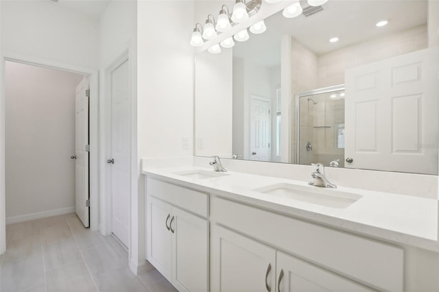 bathroom with tile patterned flooring, vanity, and a shower with door