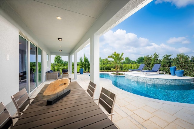 pool featuring a patio area and a jacuzzi