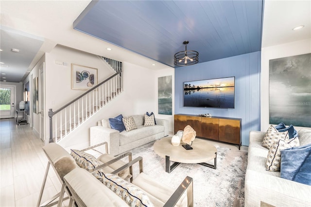 living room featuring recessed lighting and stairway