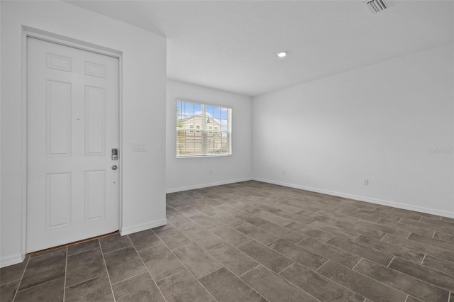 empty room with visible vents and baseboards