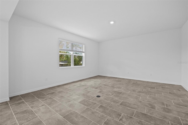 unfurnished room featuring baseboards and recessed lighting