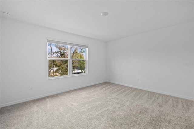 empty room with carpet floors and baseboards