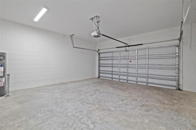 garage with concrete block wall and a garage door opener