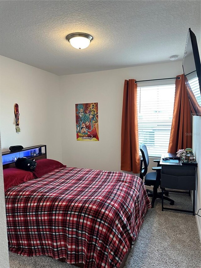 bedroom with carpet and a textured ceiling