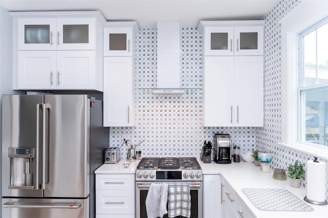 kitchen with tasteful backsplash, stainless steel appliances, and white cabinets