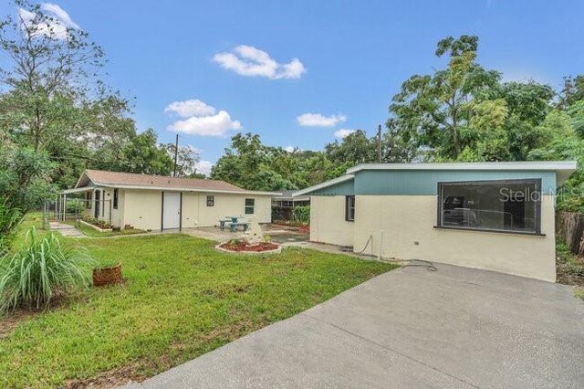 back of property featuring a lawn