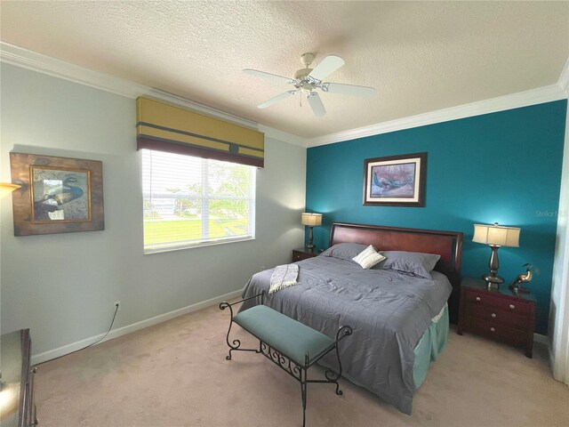 carpeted bedroom with crown molding, a textured ceiling, and ceiling fan