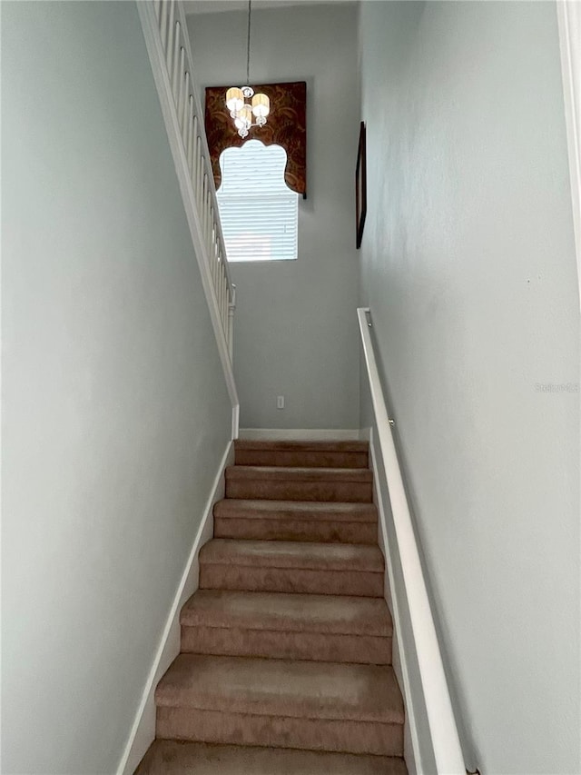 stairway with an inviting chandelier