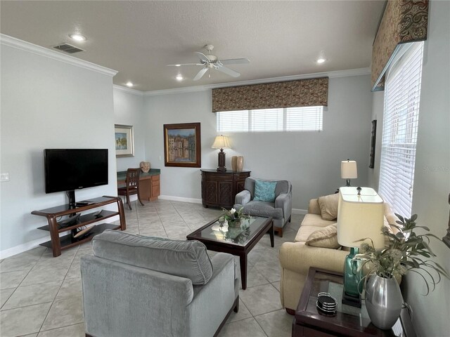 living room featuring ceiling fan, light tile patterned floors, a wealth of natural light, and ornamental molding