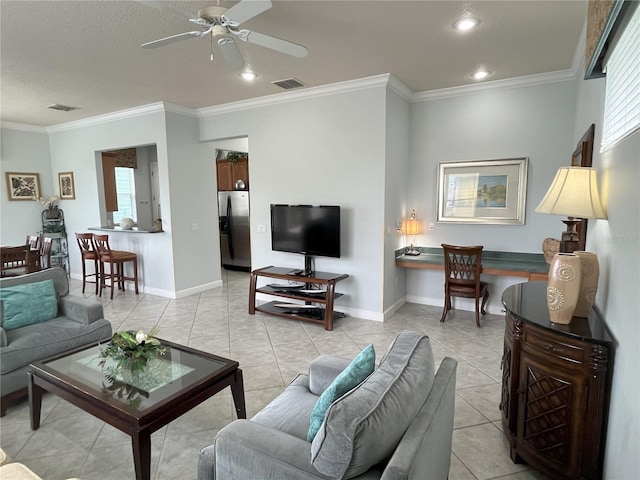 living room featuring ceiling fan, ornamental molding, and a healthy amount of sunlight